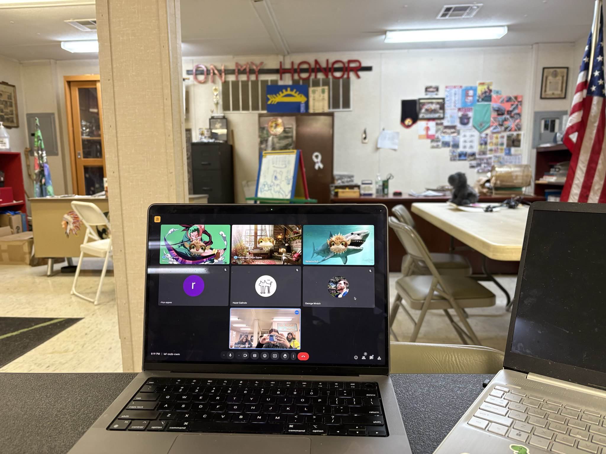crew meeting location w/ mars' laptop showing a zoom call w/ a bunch of pufferfish instead of people's faces